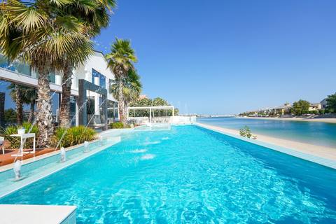 The pool and beachfront at the Ocean Oasis villa